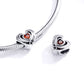Heart charm bead with orange CZ center on silver snake-chain bracelet