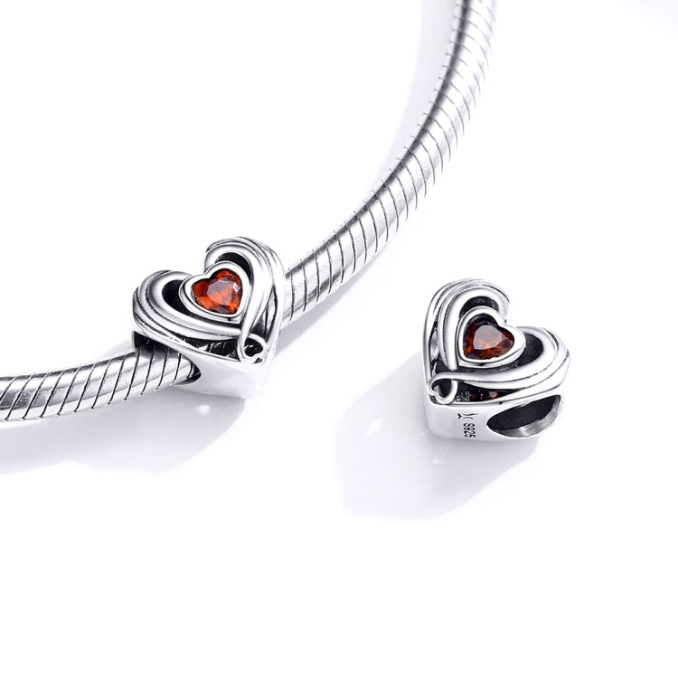 Heart charm bead with orange CZ center on silver snake-chain bracelet