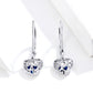Sterling silver heart drop earrings with hollow filigree and blue accents