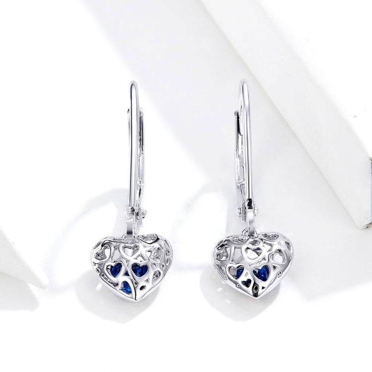 Sterling silver heart drop earrings with hollow filigree and blue accents