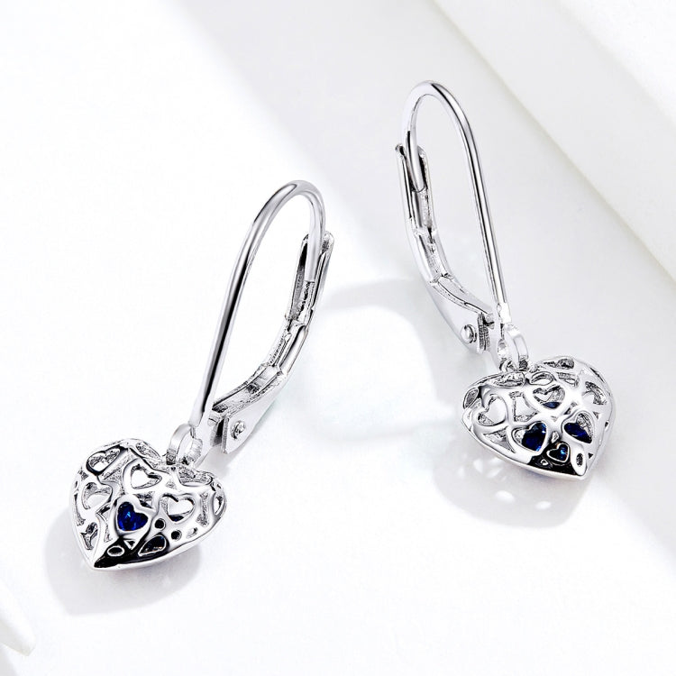 Sterling silver hollow heart drop earrings with blue accents