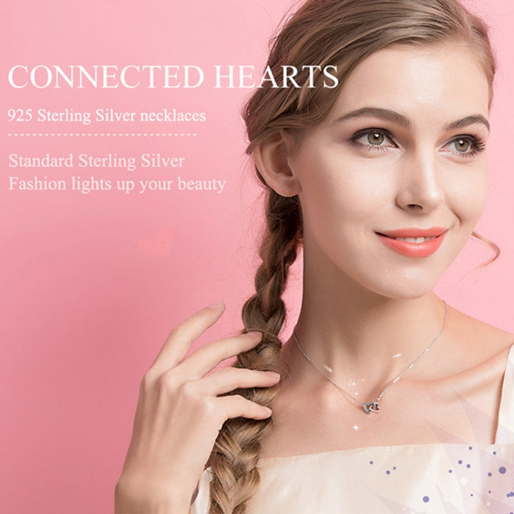 Sterling silver heart pendant necklace worn on model with fine linked chain