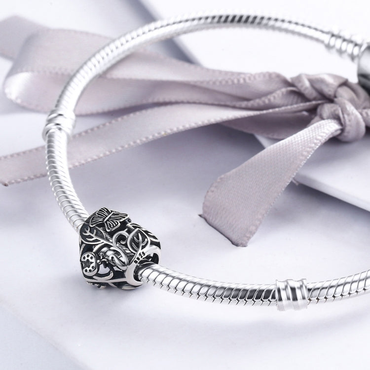 Sterling silver heart charm bead on a silver charm bracelet with a ribbon bow