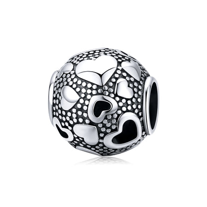 Sterling silver round heart-pattern bead charm with black enamel and white dot detailing