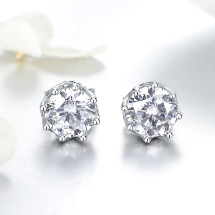 Pair of round clear zircon stud earrings in silver, angled view