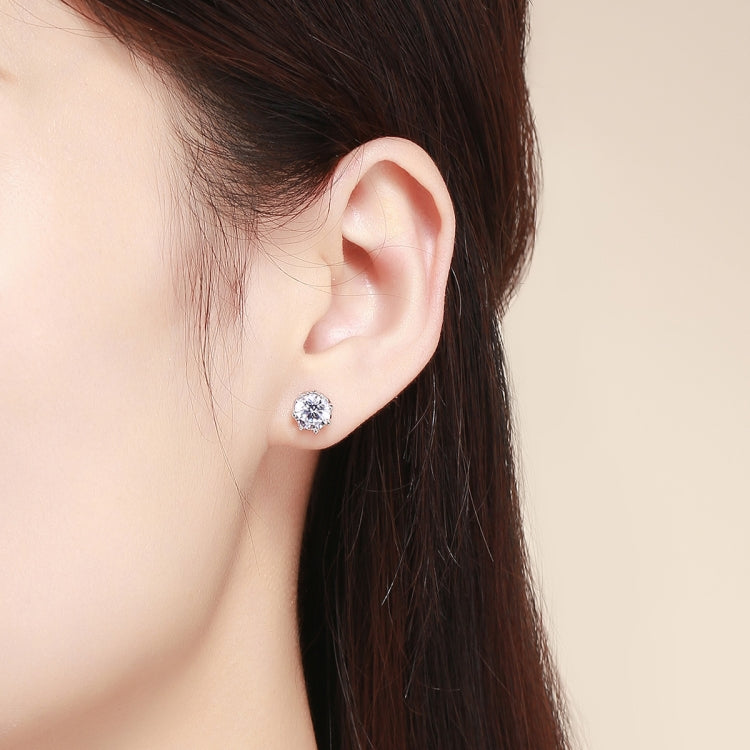 Round zircon stud earrings in sterling silver on ear, close-up