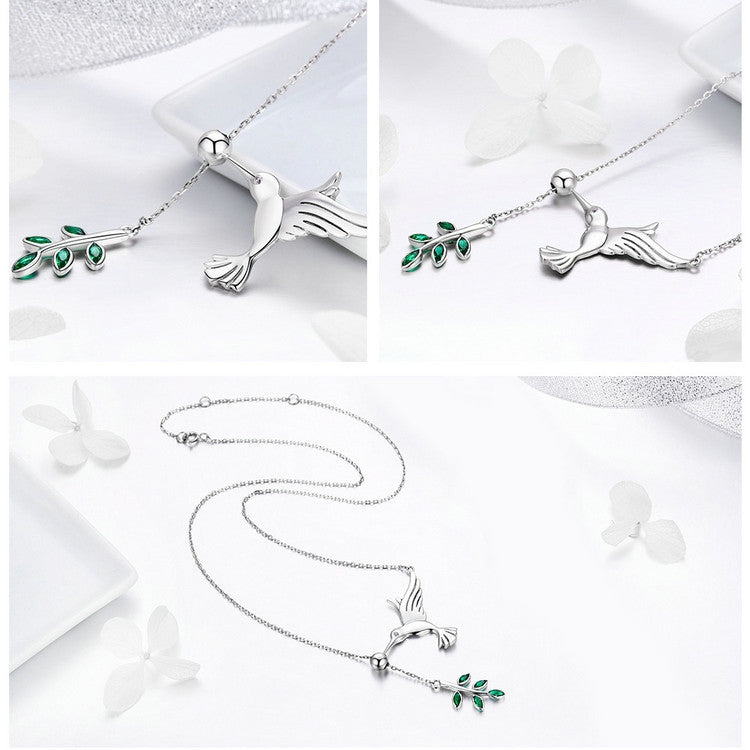 Sterling silver hummingbird necklace with green enamel flower charm and clasp