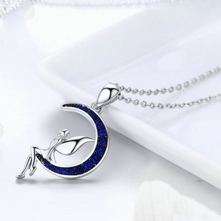 Sterling silver crescent moon pendant with blue CZ trim and fairy figure