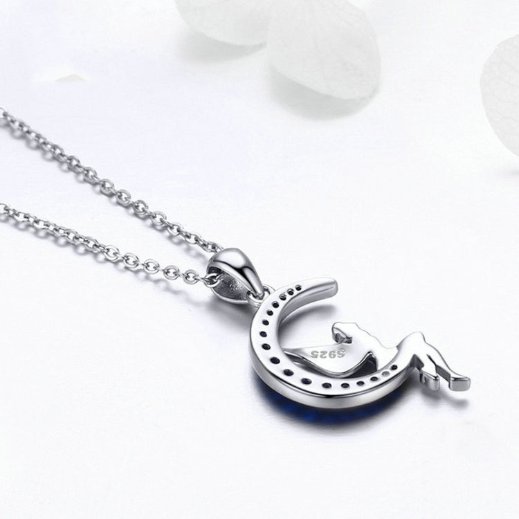 Sterling silver crescent moon pendant with blue CZ stones on a chain
