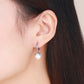 Silver hoop earring with round shell bead drop