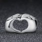 S925 sterling silver heart bead with raised holding-hands motif and heart-shaped cutout