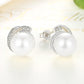 White pearl stud earrings with silver bezel halo and push-back clasps