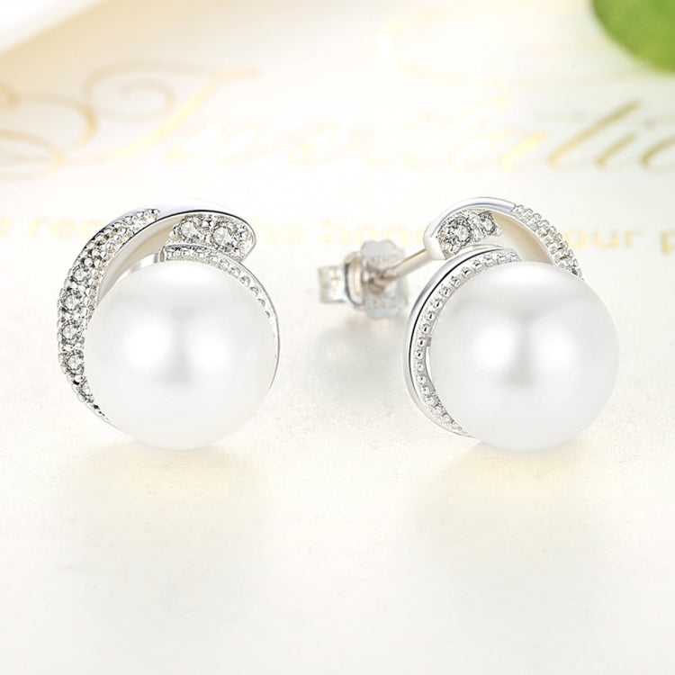 White pearl stud earrings with silver bezel halo and push-back clasps