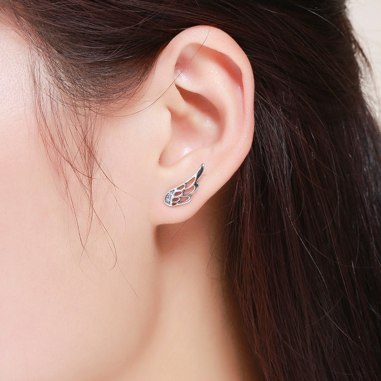 Sterling silver wing stud earring on ear