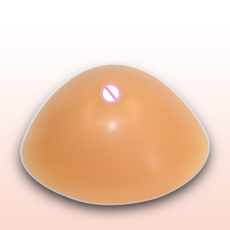 Tan silicone breast form with triangular shape and concave bottom