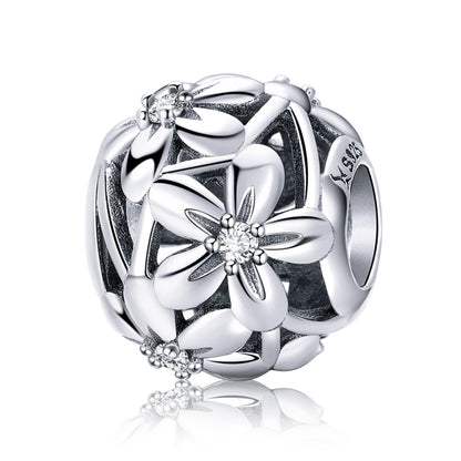 Sterling silver flower charm bead with dripping-oil motif and small CZ-like center