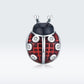 Front-facing oxidized silver ladybug pendant charm with red enamel and CZ accents
