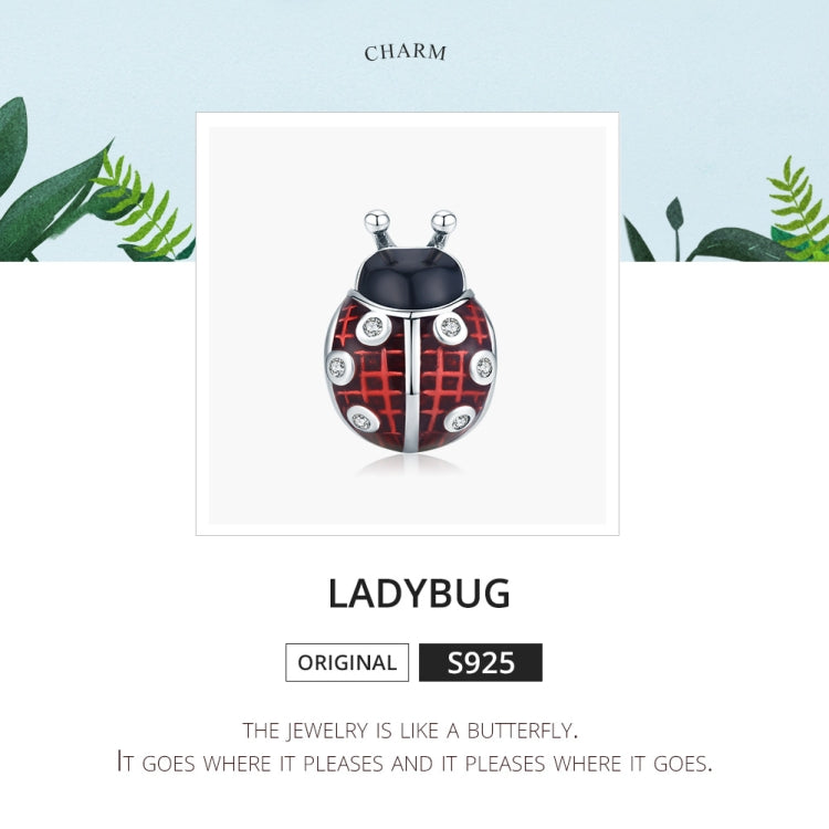 Ladybug charm pendant on display card, red enamel wings and CZ stone details