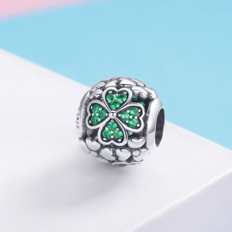 S925 sterling silver clover charm bead with four-leaf green gemstone petals, side view