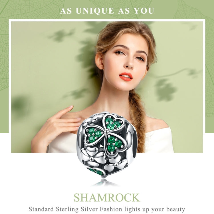 Clover charm bead in oxidized silver with green stones, shown on a necklace
