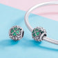 Two S925 clover charm beads with green stones on a silver bracelet chain