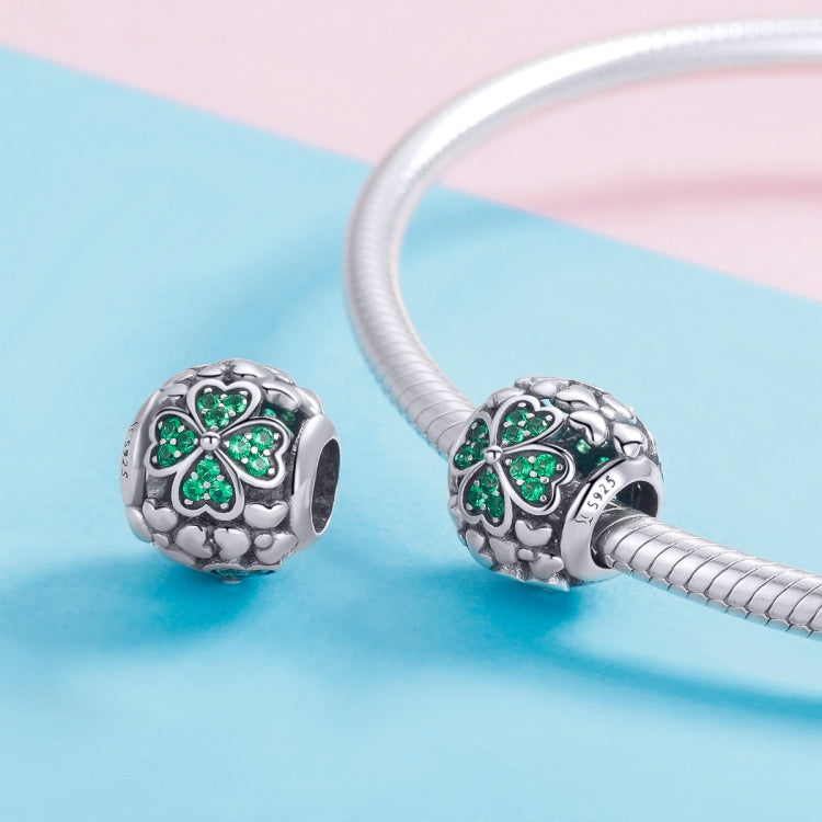 Two S925 clover charm beads with green stones on a silver bracelet chain
