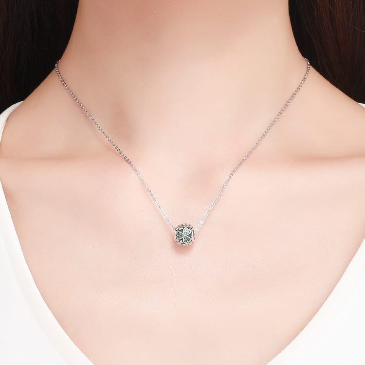 Silver necklace chain with round clover pendant bead set with green stones