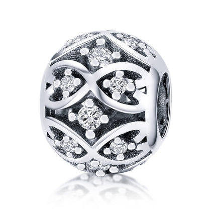 Sterling silver bead with black enamel filigree and sparkling crystal accents