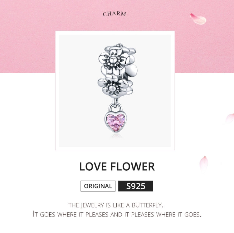 Silver flower charm bead with pink heart pendant, looped charm bale