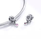 Silver charm bead with flower design and pink heart CZ pendant