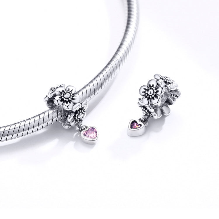 Silver charm bead with flower design and pink heart CZ pendant