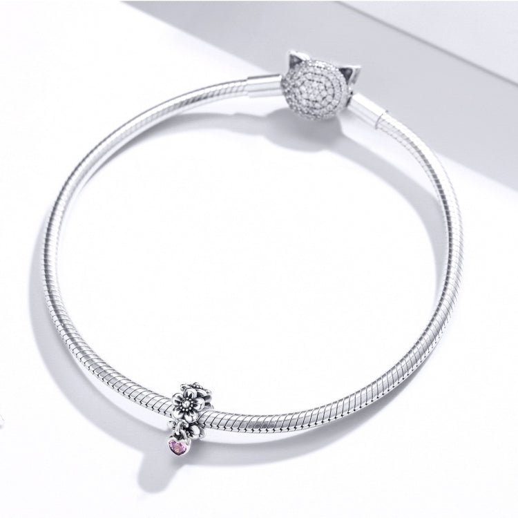 Silver snake-chain bracelet with flower charm and pink heart charm bead