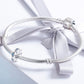 Silver charm beads on snake chain bracelet with blue crystal eye motifs