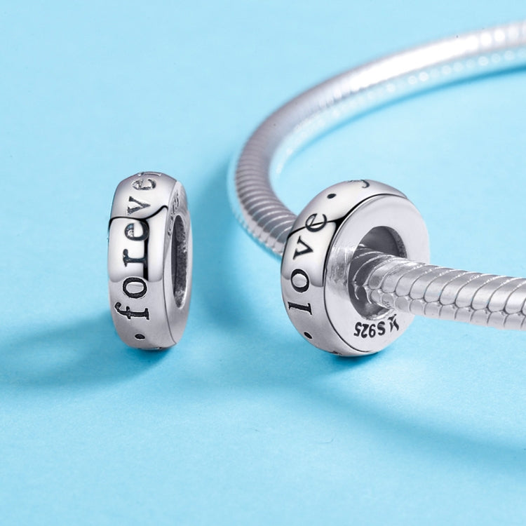 Pair of sterling silver heart charm beads with “love you” on a bracelet