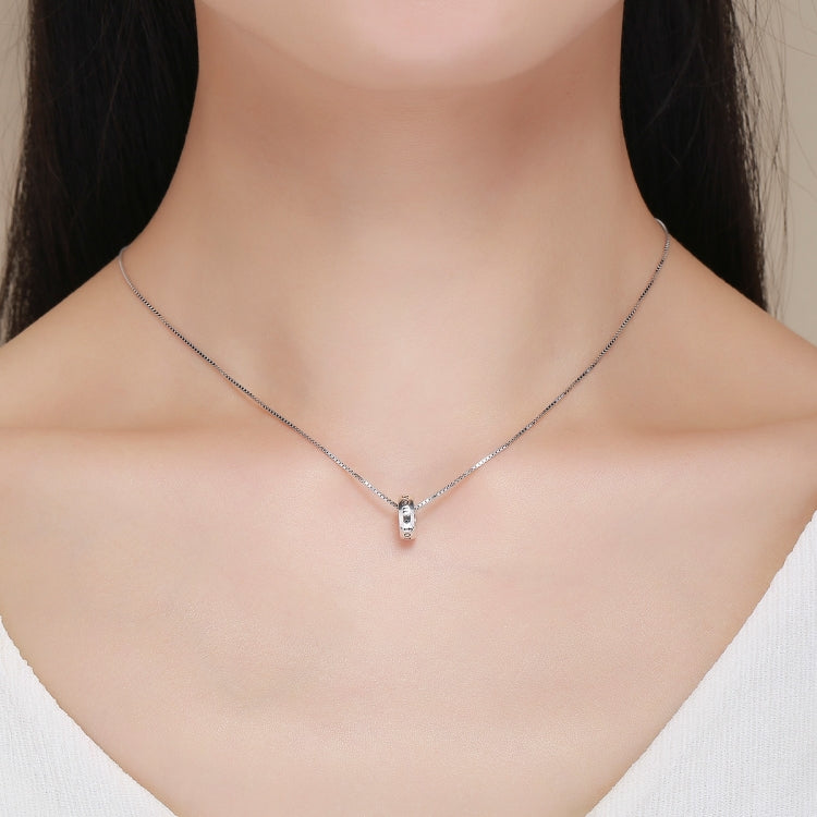 Sterling silver heart charm bead necklace on the collarbone
