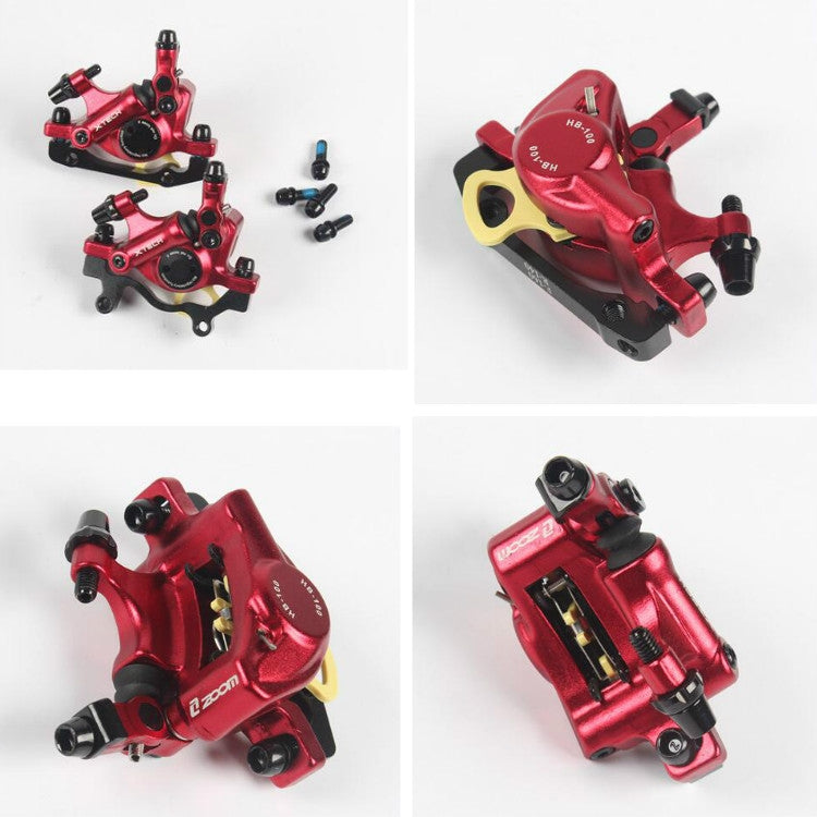 Red hydraulic disc brake caliper, side view, with mounting bracket and ports