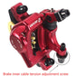 Red hydraulic disc brake caliper close-up with black cable fitting and mounting bolts