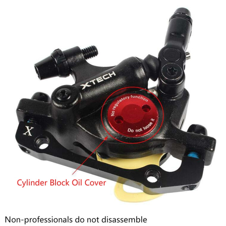 Black hydraulic disc brake caliper close-up with yellow cover and regulator dial
