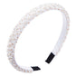 Crystal beaded fabric headband in white with black fabric tips and a curved fit