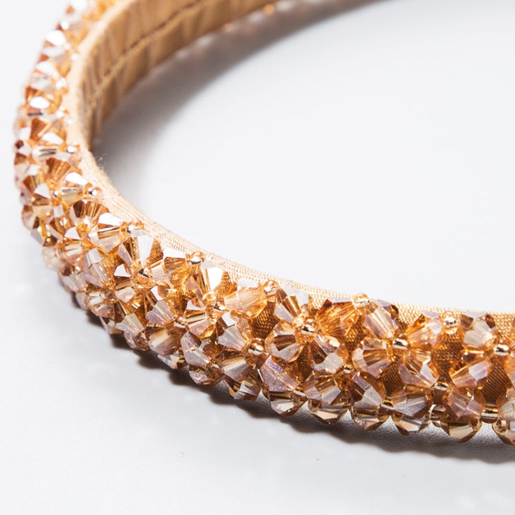 Close-up of warm tan/copper crystal beaded headband with textured fabric edge