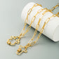 Gold-tone cross pendant necklace with two cross charms and zircon bands on link chain