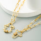Gold-tone cross pendant necklace featuring two cross pendants with zircon bands, link chain