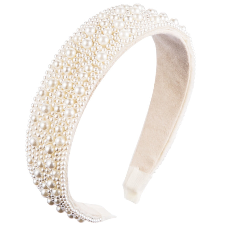 Cream fabric headband fully covered with white faux pearls, wide embellished band.