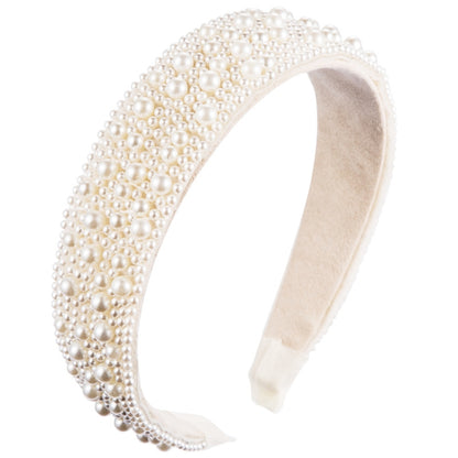 Cream fabric headband fully covered with white faux pearls, wide embellished band.
