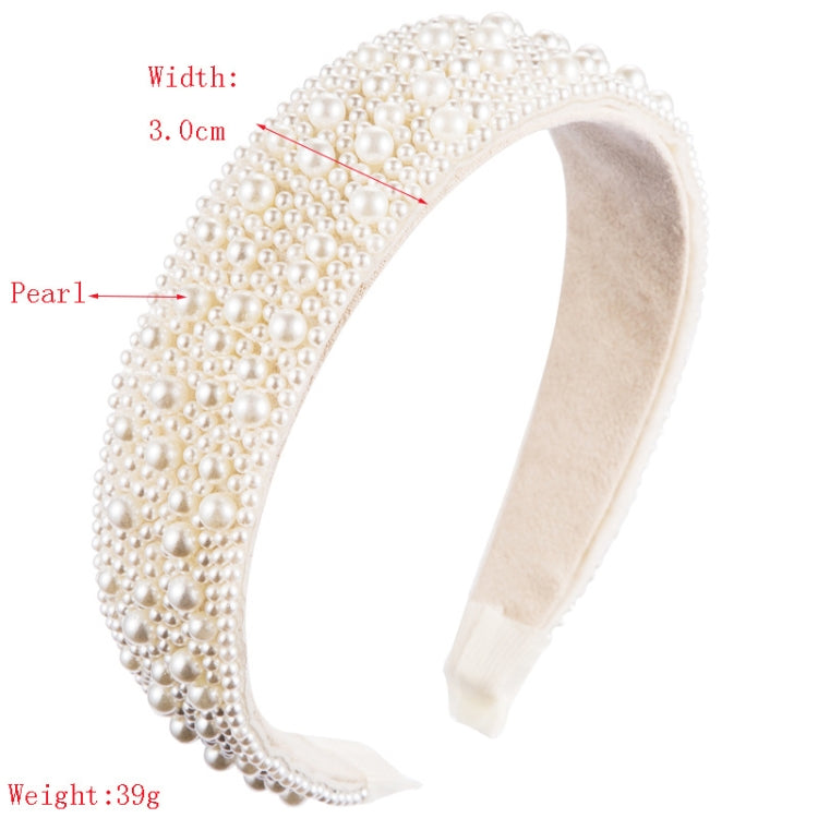 Wide white faux pearl headband with beige interior lining and beaded fringe edges.