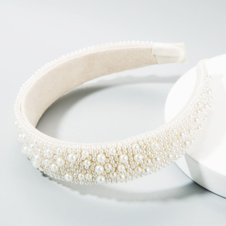 Pearl headband with cream inner band, layered rows of white beads along the crown.
