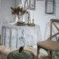 White round lace tablecloth with detailed damask motifs, draped over table
