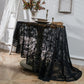 Black round lace tablecloth with scalloped edge and ornate floral damask