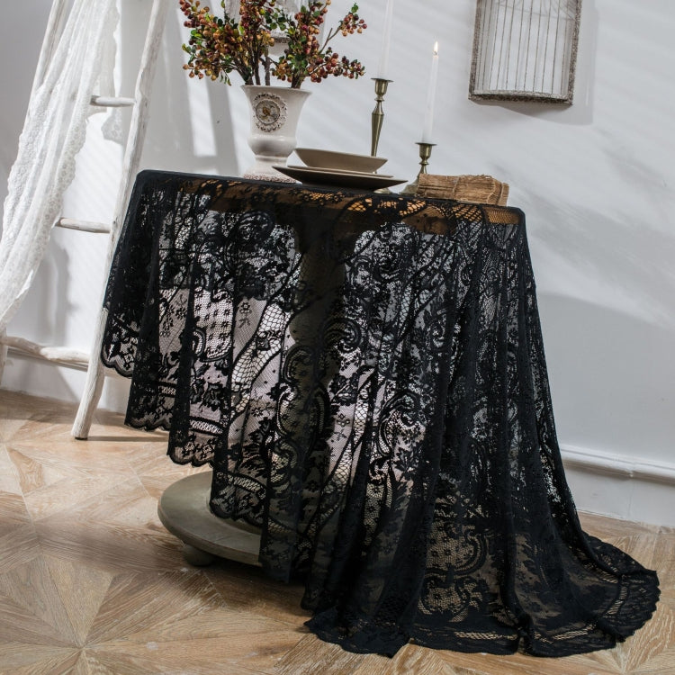 Black round lace tablecloth with scalloped edge and ornate floral damask