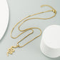 Gold snake pendant necklace with zircon-studded pendant and long link chain